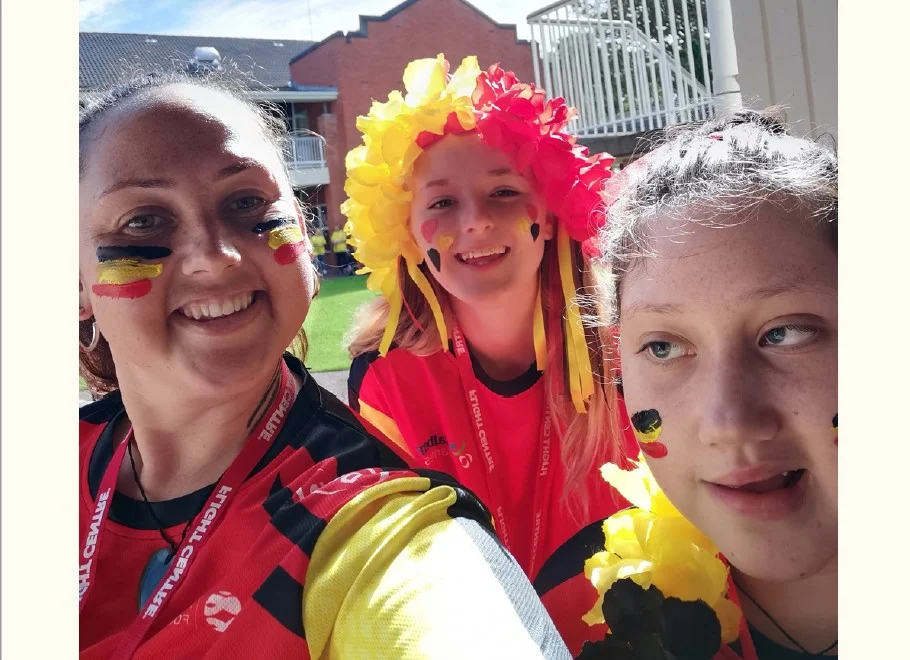 Selfie of three people at the Halberg Games. They are wearing Waikato colours of red, yellow, and black