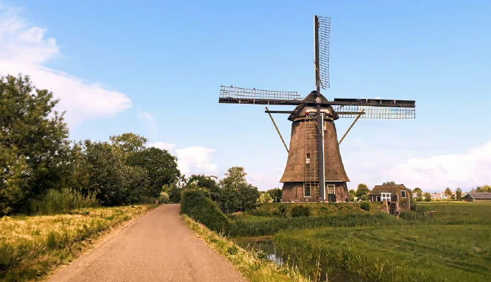 country road and windmill in holland