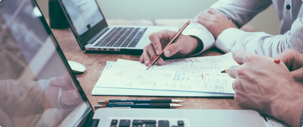 paper and laptop on a desk