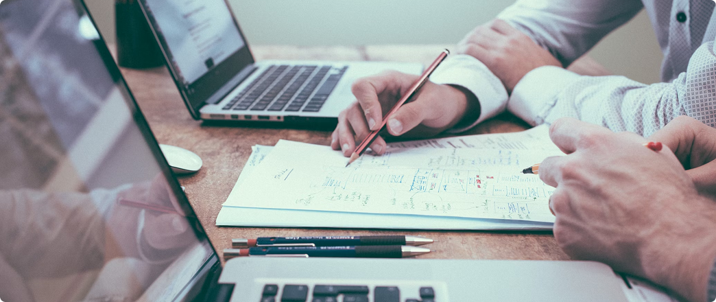 paper and laptop on a desk